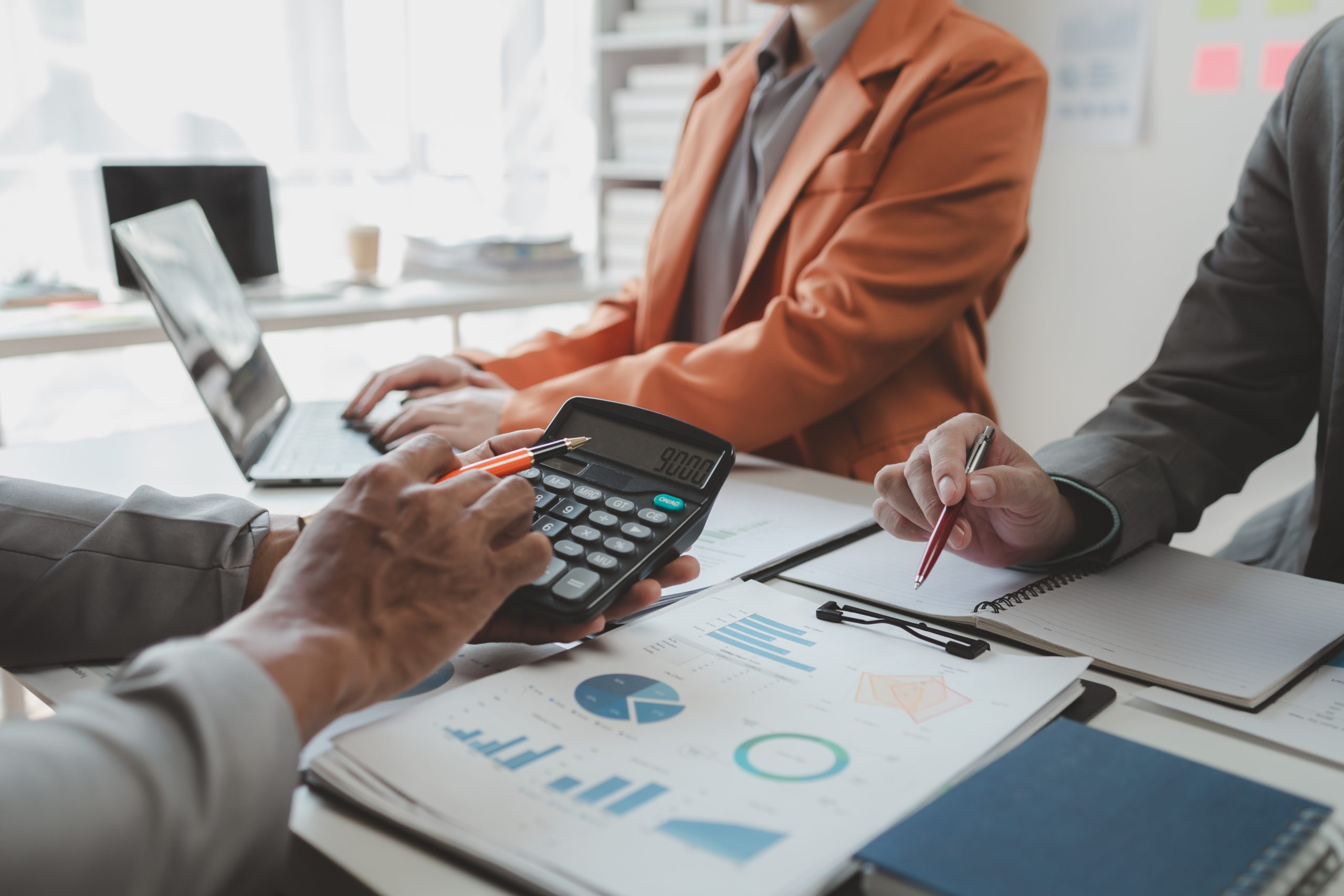 Calculate the numbers according to the report sent to the meeting, They are calculating the taxes they have to pay, They are having a meeting about the company's income and expenses,
