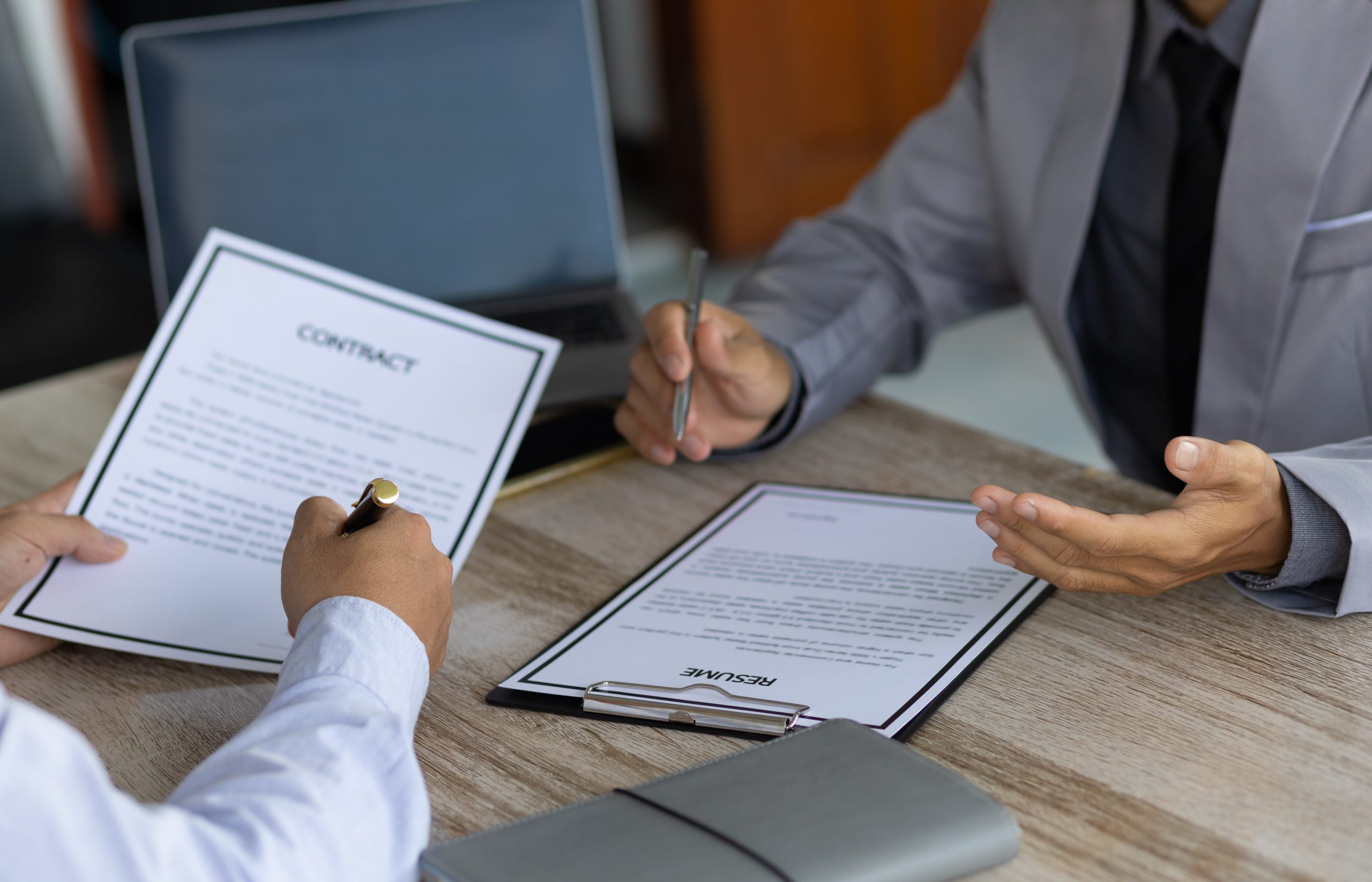 Job interview and signing of employment contract documents.